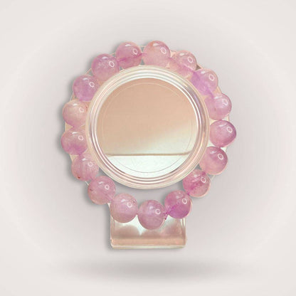 Lavender Amethyst Beaded Bracelet 12mm displayed on a clear stand, showcasing its calming purple hues and polished natural stone beads.