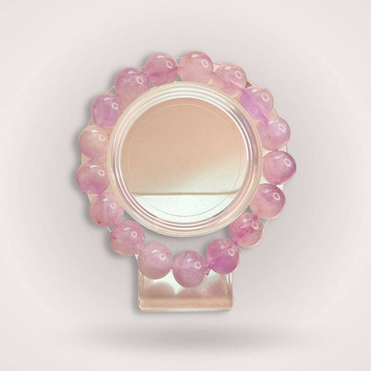 Lavender Amethyst Beaded Bracelet 12mm displayed on a clear stand, showcasing its calming purple hues and polished natural stone beads.