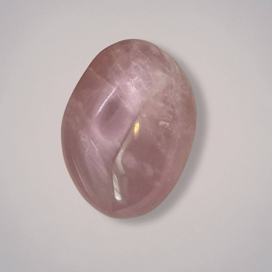 Large rose quartz palm stone from Madagascar with a polished, plummy pink surface, ideal for heart healing and emotional balance.