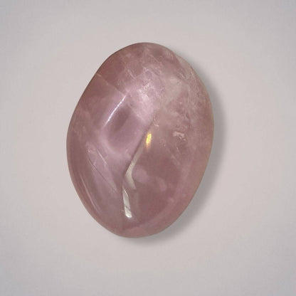 Large rose quartz palm stone from Madagascar with a polished, plummy pink surface, ideal for heart healing and emotional balance.