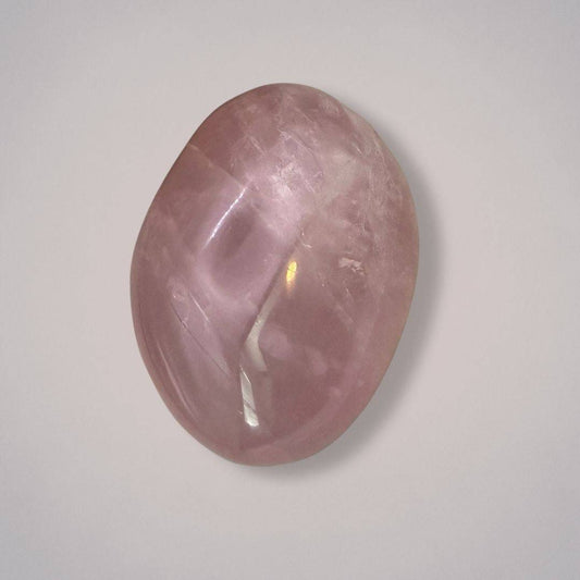 Large rose quartz palm stone from Madagascar with a polished, plummy pink surface, ideal for heart healing and emotional balance.