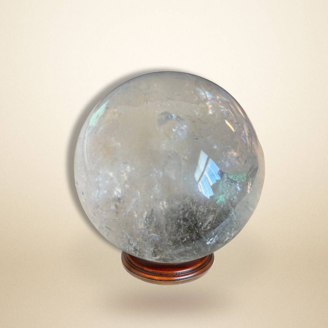 Lodolite Garden Quartz Sphere for meditation and manifestation on wooden stand, ideal for visionary work and spiritual altars.