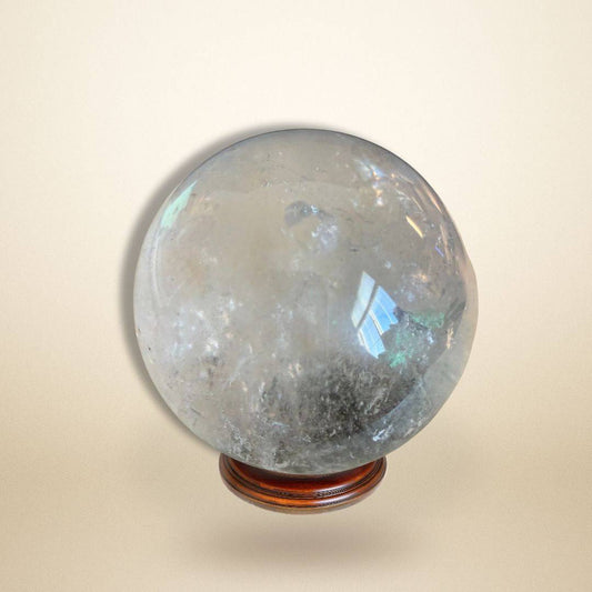 Lodolite Garden Quartz Sphere for meditation and manifestation on wooden stand, ideal for visionary work and spiritual altars.