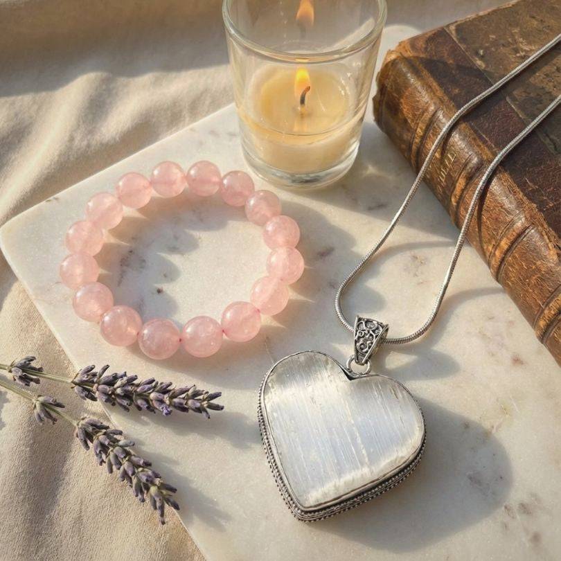 Bond of the Heart aligned pairing with Selenite heart pendant and Rose Quartz bracelet, styled with candle and lavender for love energy.