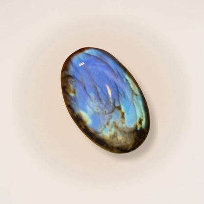 Medium Labradorite palm stone with vivid blue flash, polished for use in intuition and aura protection rituals. Ideal for crystal collectors.