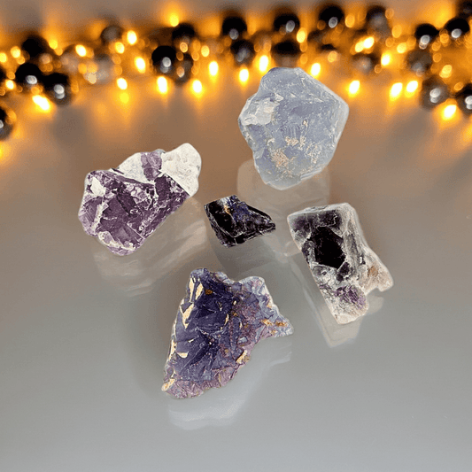 Brazilian Purple Fluorite crystal specimens in varied raw formations, ideal for clarity, focus, and spiritual alignment in gemstone collections.