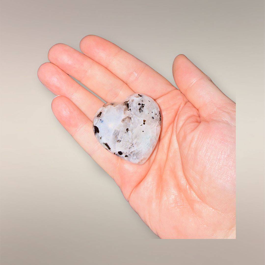 Polished Madagascar heart stone held in an open hand to show approximate 45–55mm size.