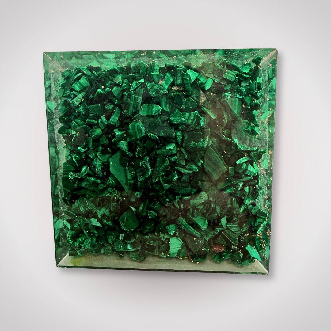 Bottom view of malachite orgonite pyramid showcasing dense green malachite chips, emphasizing its decorative and energetic properties.