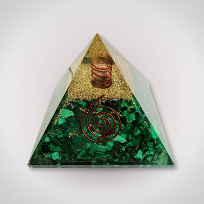 Malachite orgonite pyramid with quartz point and dual copper spirals for grounded energy and transformation. Ideal for home decor or ritual use.