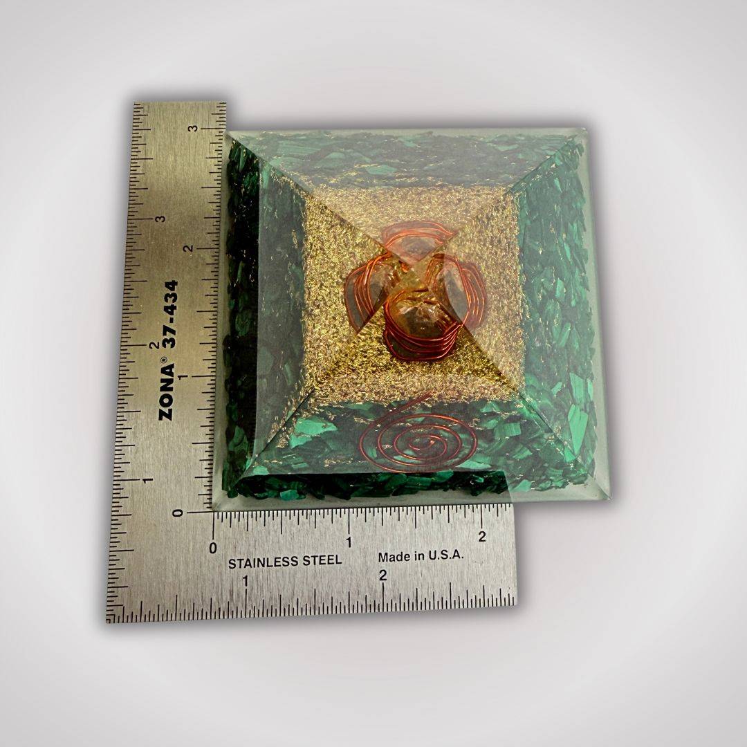 Malachite orgonite pyramid with quartz point and copper spirals shown next to ruler for size reference, ideal for home decor and energy work.