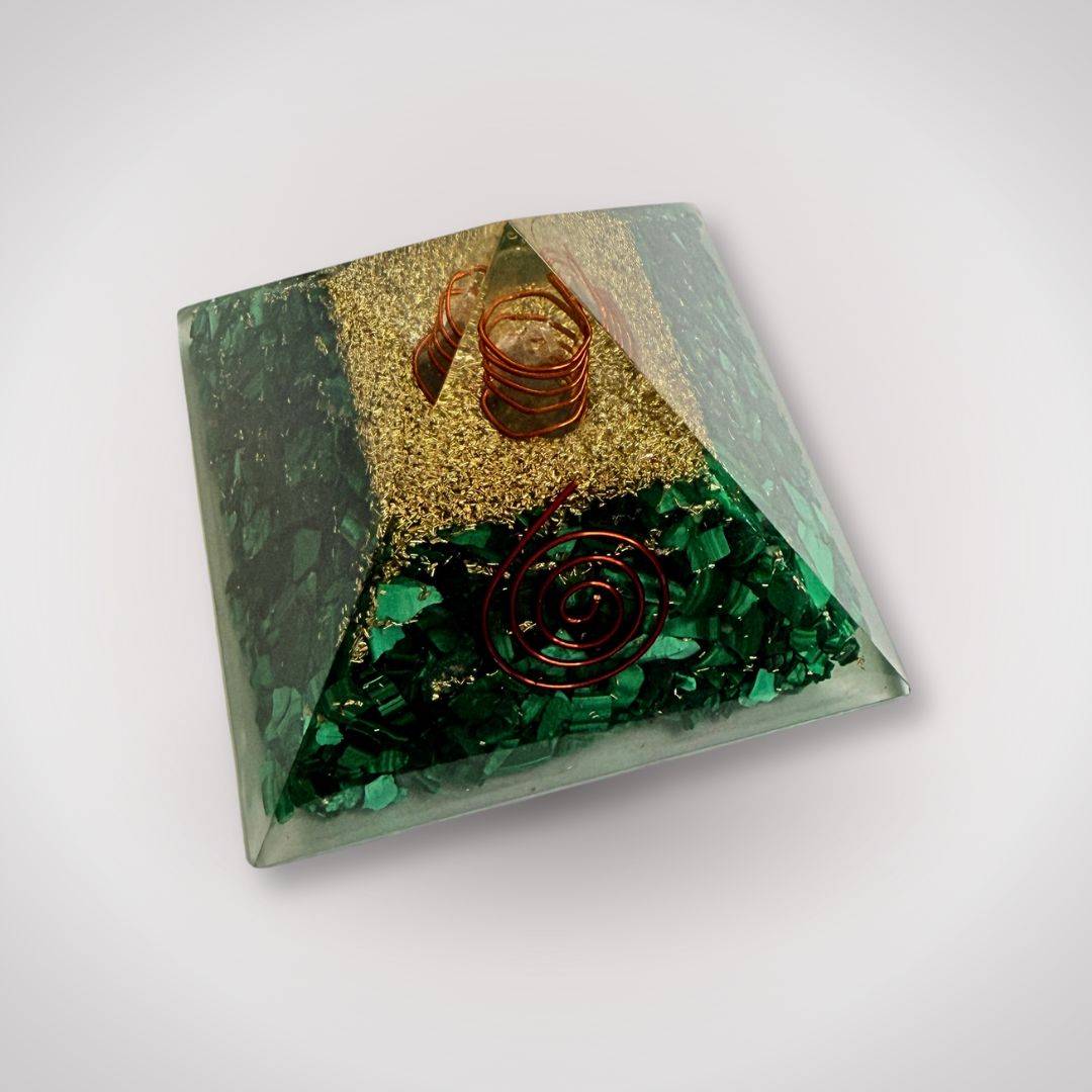 Angled view of malachite orgonite pyramid featuring quartz point and copper spirals, perfect for grounding energy in home or meditation spaces.
