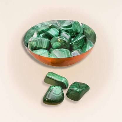 Copper bowl filled with Malachite Tumbled Stones, perfect for decorative bowls in home and garden decor with healing energy appeal.
