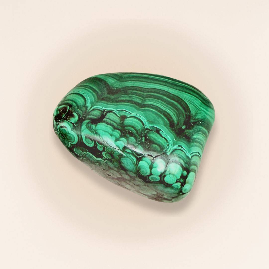 Polished Malachite Tumbled Stone showcasing vivid green banding, ideal for balance and divine healing in home decor or spiritual use.