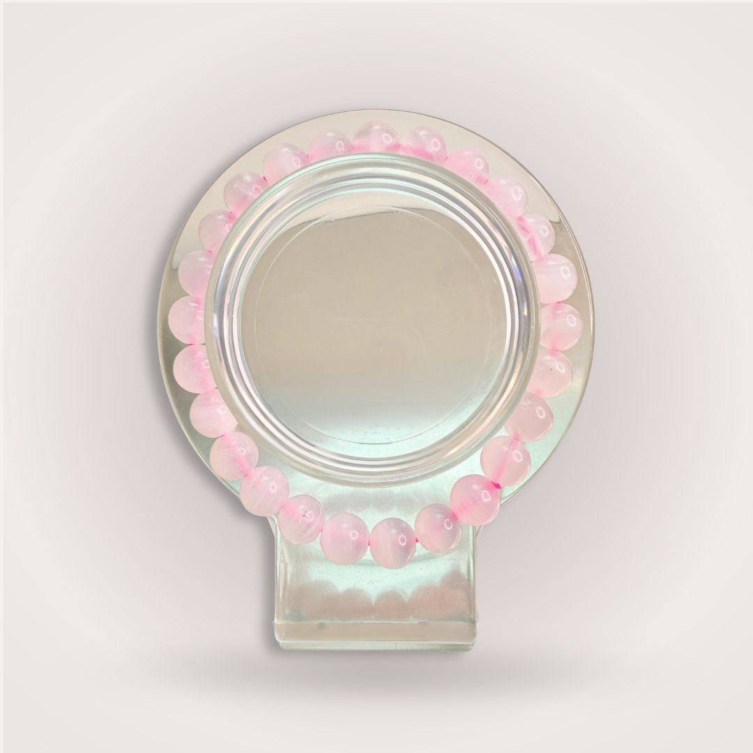 Manganese Calcite bracelet from the Thread of Companionship Aligned Pairing | Friendship Jewelry Set, with soft pink beads arranged in a circular display.