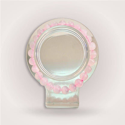 Manganese Calcite bracelet from the Thread of Companionship Aligned Pairing | Friendship Jewelry Set, with soft pink beads arranged in a circular display.