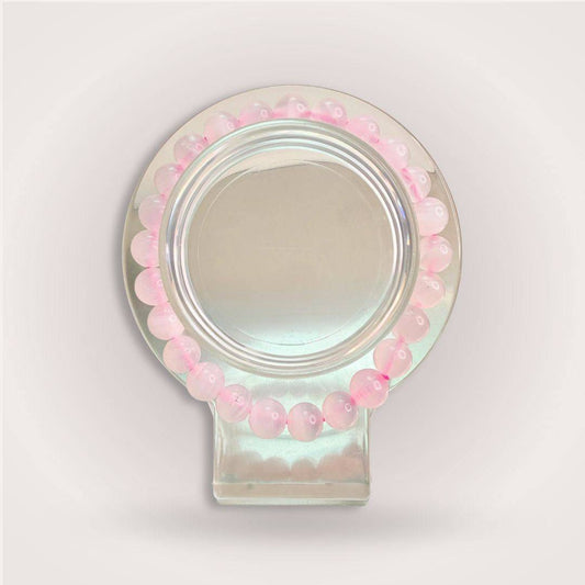 Manganese Calcite bracelet from the Thread of Companionship Aligned Pairing | Friendship Jewelry Set, with soft pink beads arranged in a circular display.