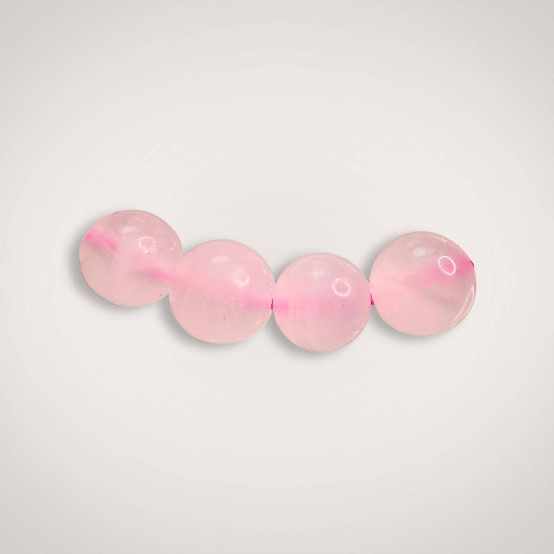Close-up of four 8mm Mangano Calcite beads in soft pink, highlighting their smooth finish and calming energy for emotional healing.