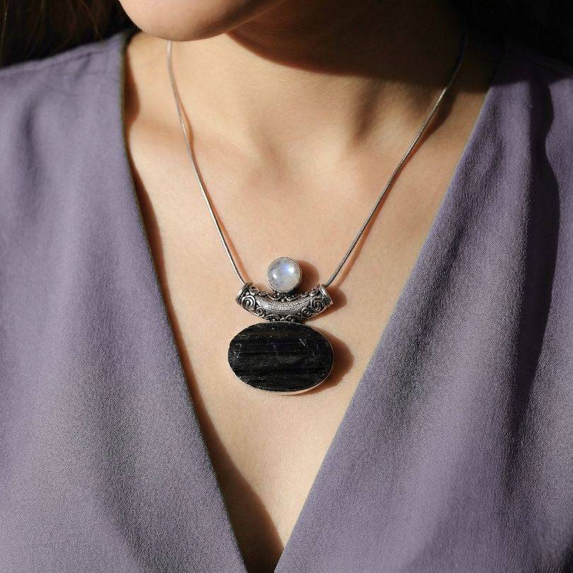 Moonstone & Black Tourmaline Pendant worn on model, showcasing elegant silver setting and grounding crystal design for spiritual protection.