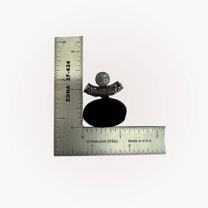 Moonstone & Black Tourmaline Pendant next to ruler for scale, highlighting size and handcrafted silver bezel design for grounding energy.