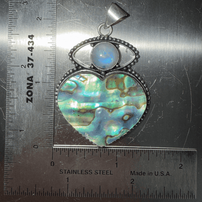 Rainbow Moonstone Evil Eye & Abalone Heart Pendant with sterling silver setting, featuring iridescent abalone shell and protective moonstone cabochon.