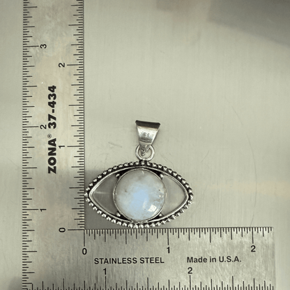 Rainbow Moonstone Evil Eye Pendant in sterling silver with beaded detailing, shown next to ruler for size reference. Enhances intuition and protection.