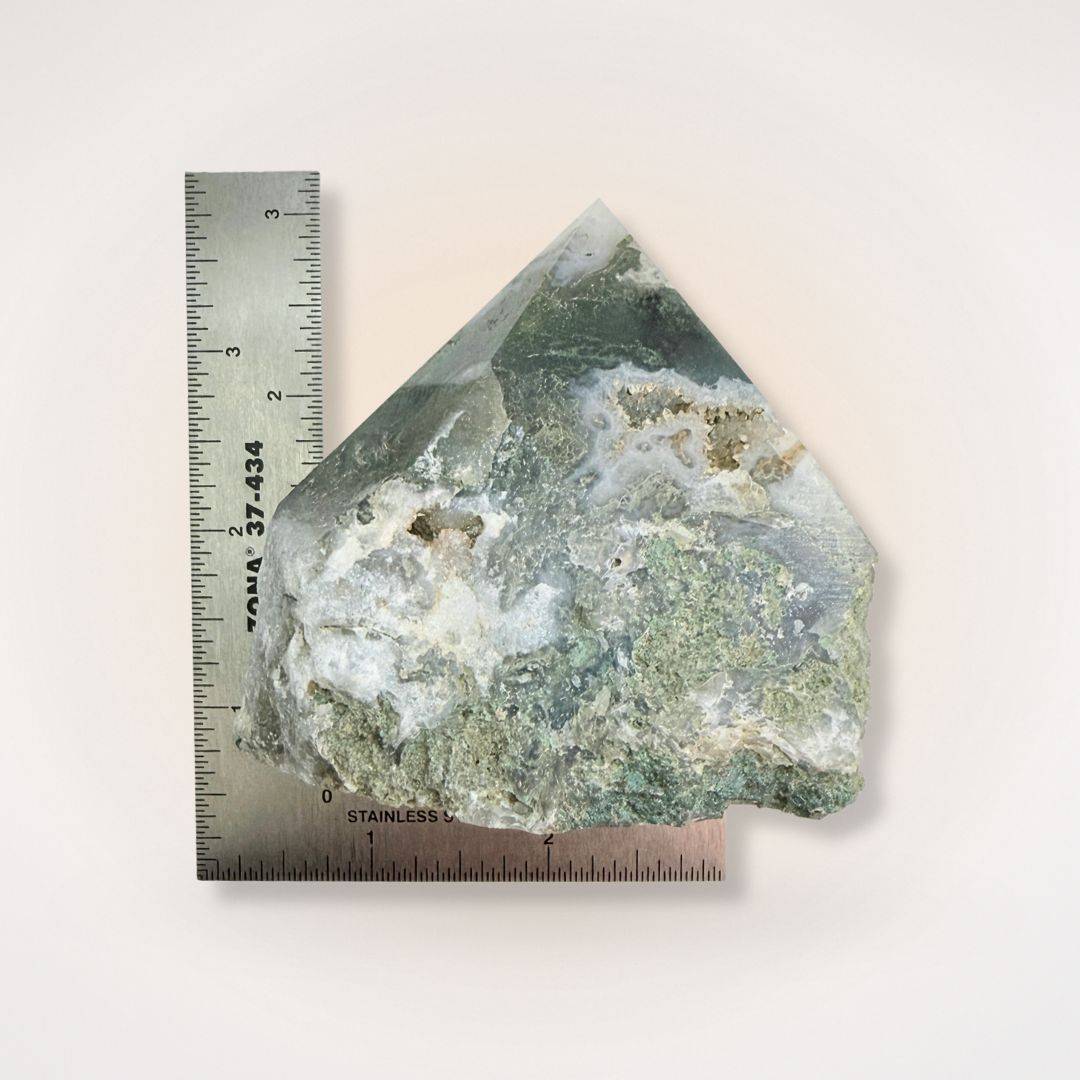 Moss Agate top polish natural sided point shown with ruler for scale, highlighting its size and raw texture for collectors and crystal enthusiasts.