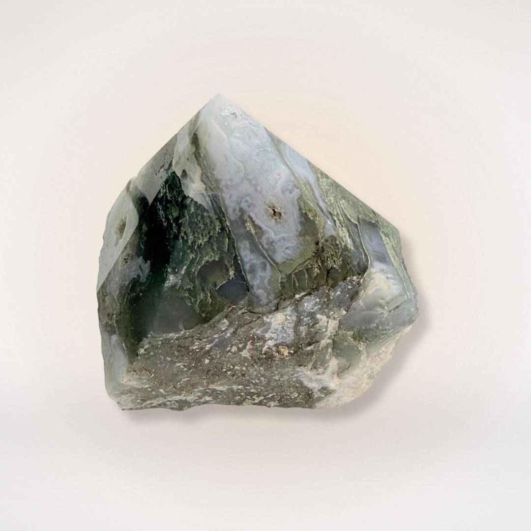 Polished Moss Agate tower featuring natural green inclusions and raw base, used for balance and growth in gemstone and crystal collections.