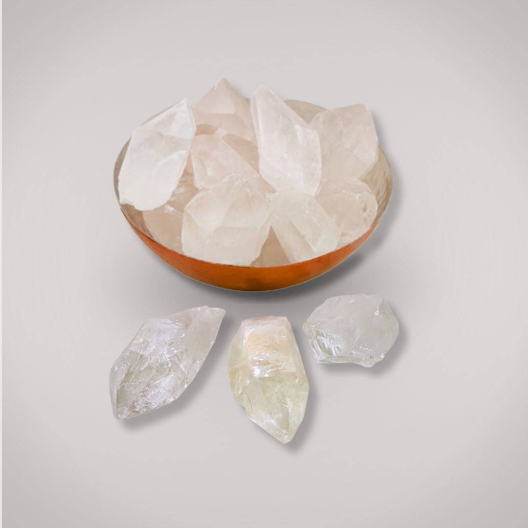 Collection of Clear Quartz Terminated Points in a copper bowl with three crystals displayed outside, perfect for healing and energy work.