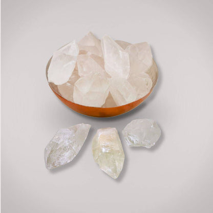 Collection of Clear Quartz Terminated Points in a copper bowl with three crystals displayed outside, perfect for healing and energy work.