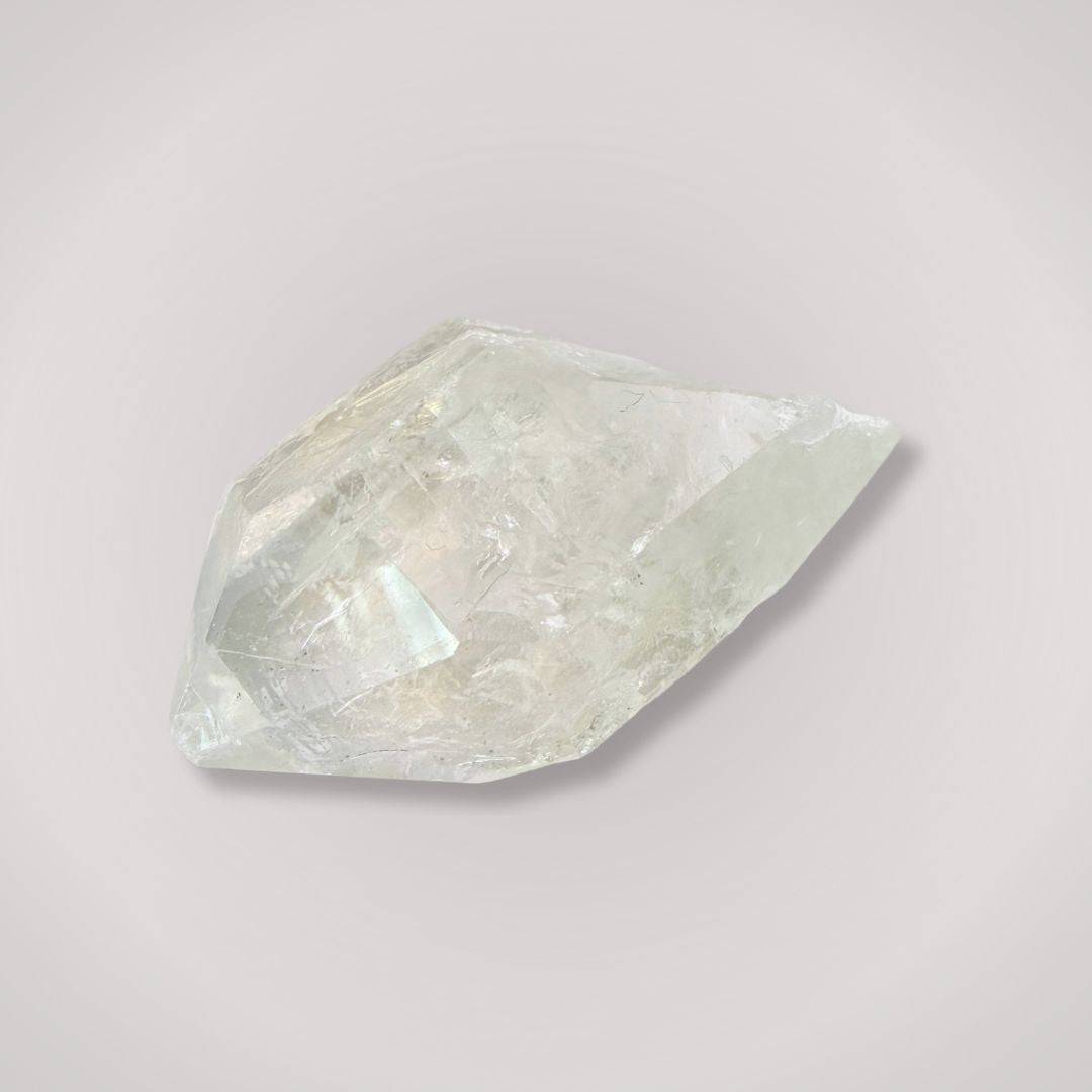 Clear Quartz Terminated Point crystal weighing 50–100g, showcasing natural clarity and faceted termination for energy amplification and healing.