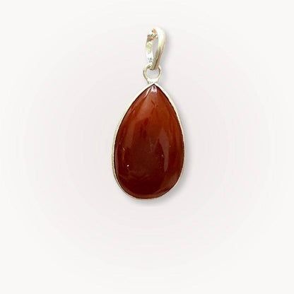 Carnelian teardrop pendant from the Path of Prosperity Aligned Pairing, symbolizing inspired action and confidence for abundance seekers.