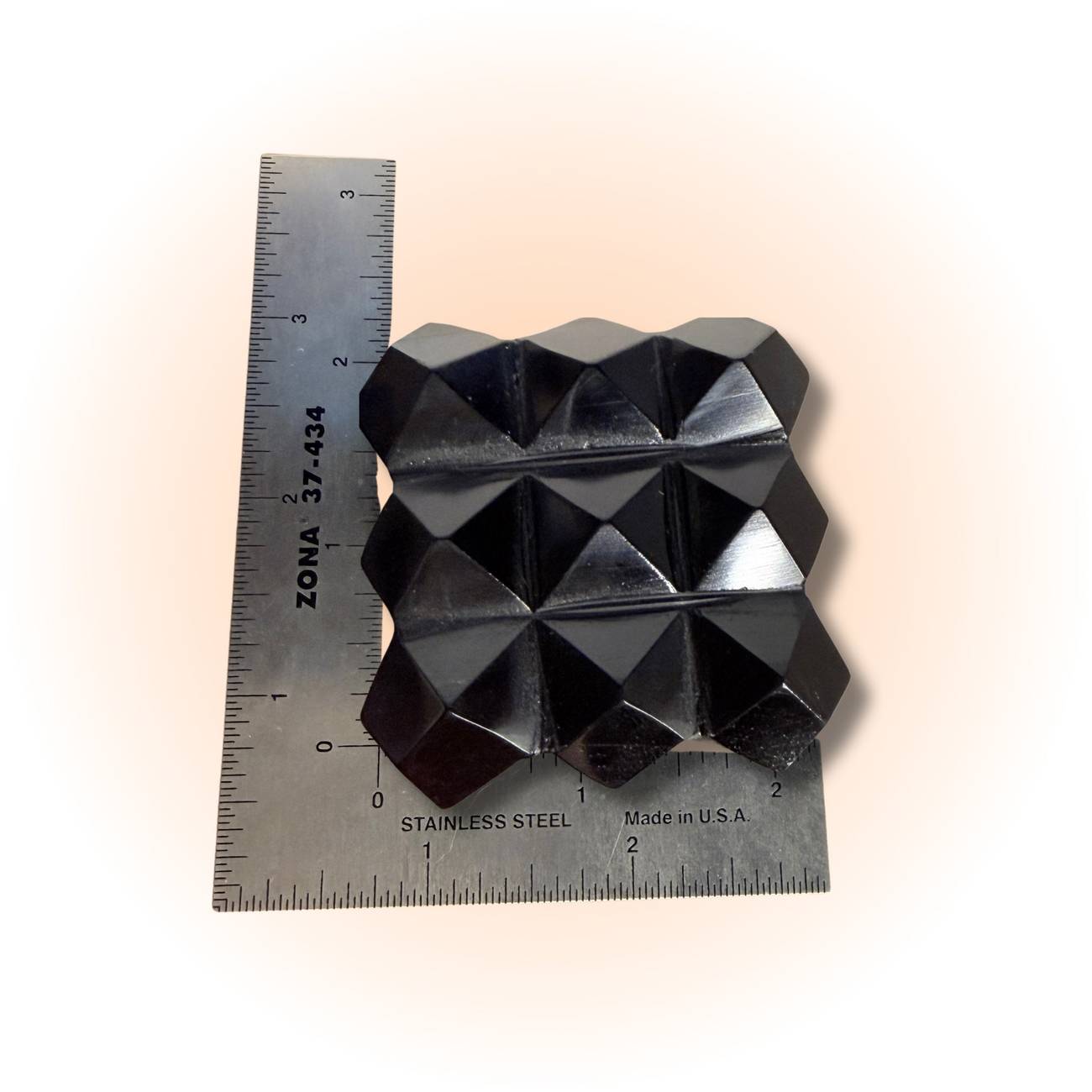Obsidian Cube - Sacred Geometry featuring a geometric pyramid grid design, shown with ruler for scale. Ideal for grounding and energy protection.
