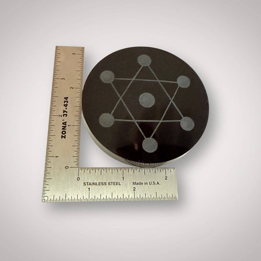 Obsidian hexagram crystal grid plate 80mm shown with ruler for scale, highlighting its compact size for altar or ritual use in home decor.