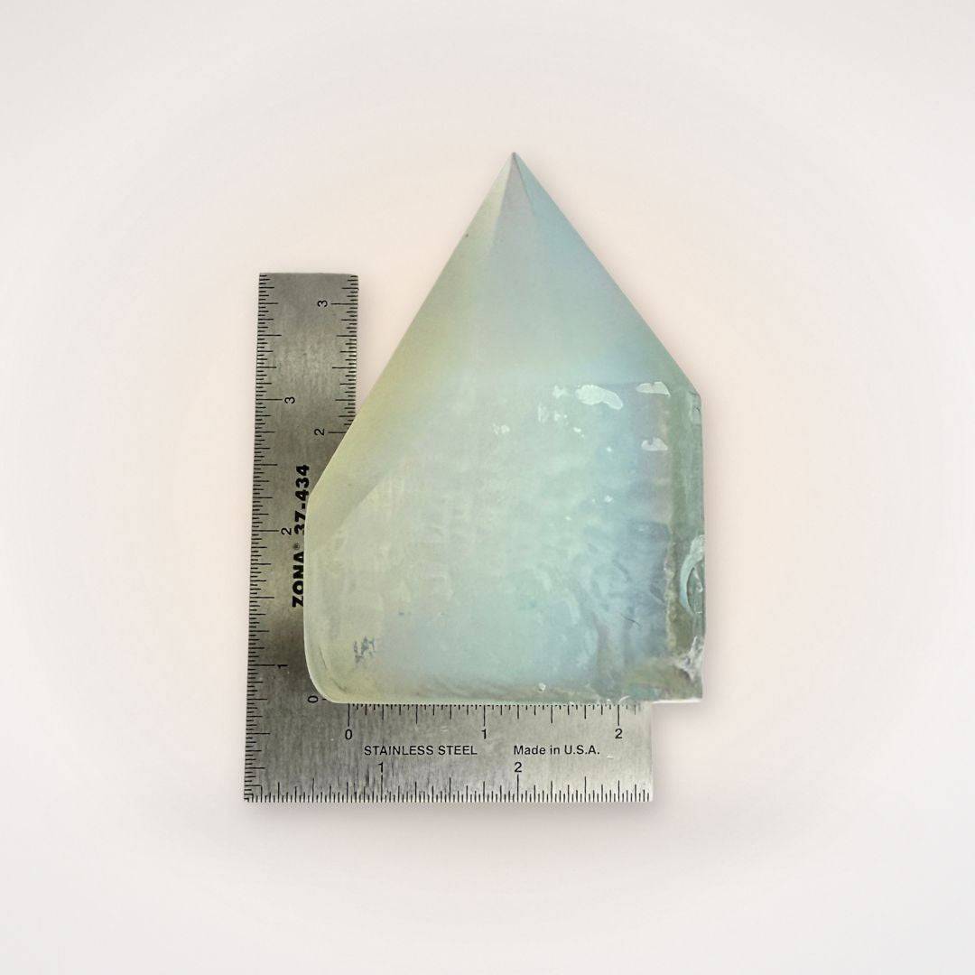 Opalite top polish point tower shown with ruler for scale, highlighting its size and clarity for home decor or spiritual use.