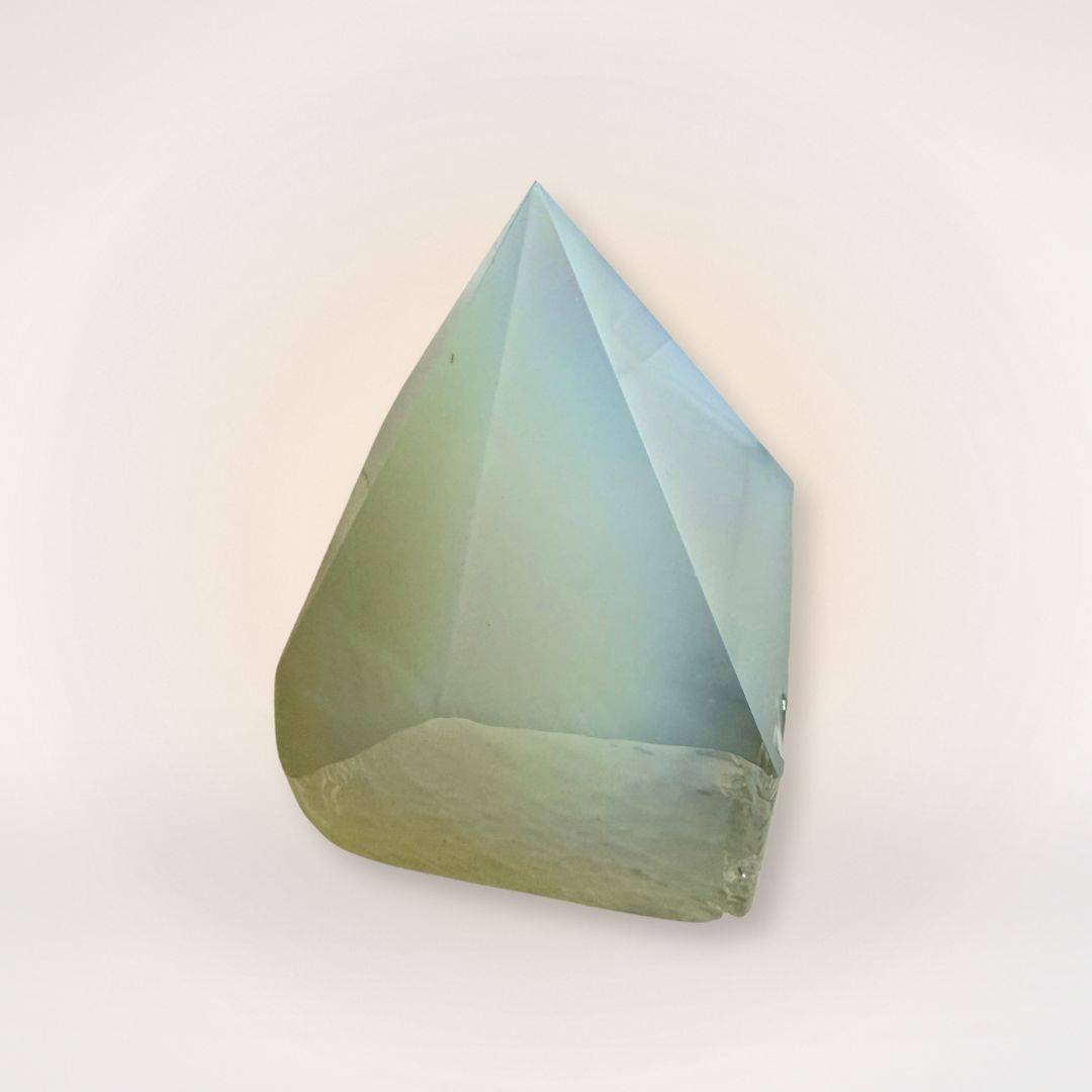 Polished Opalite point tower with a soft glow and faceted top, perfect for emotional balance and decorative use in any room.