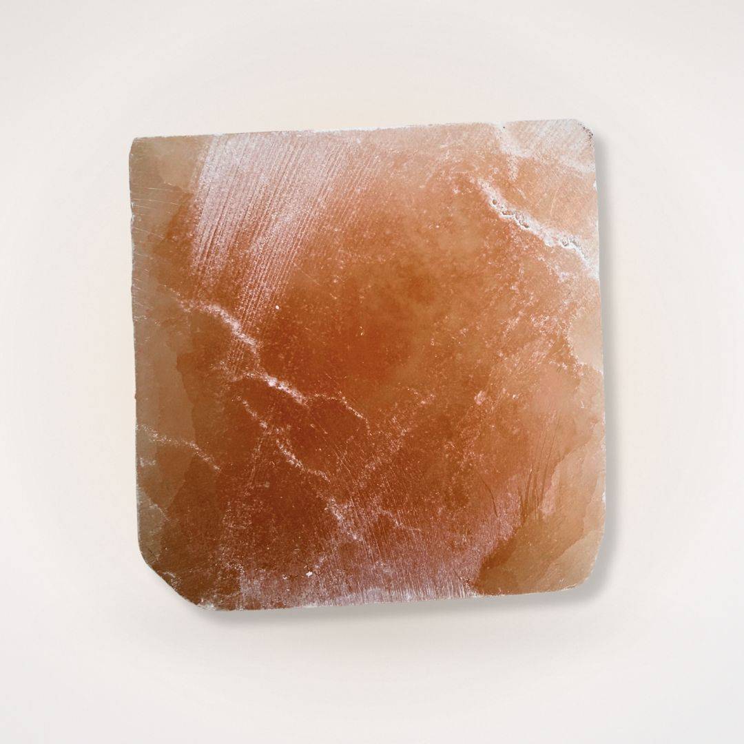 Bottom view of Orange Selenite Pyramid showing raw crystal base texture, ideal for grounding energy in decor and meditation.