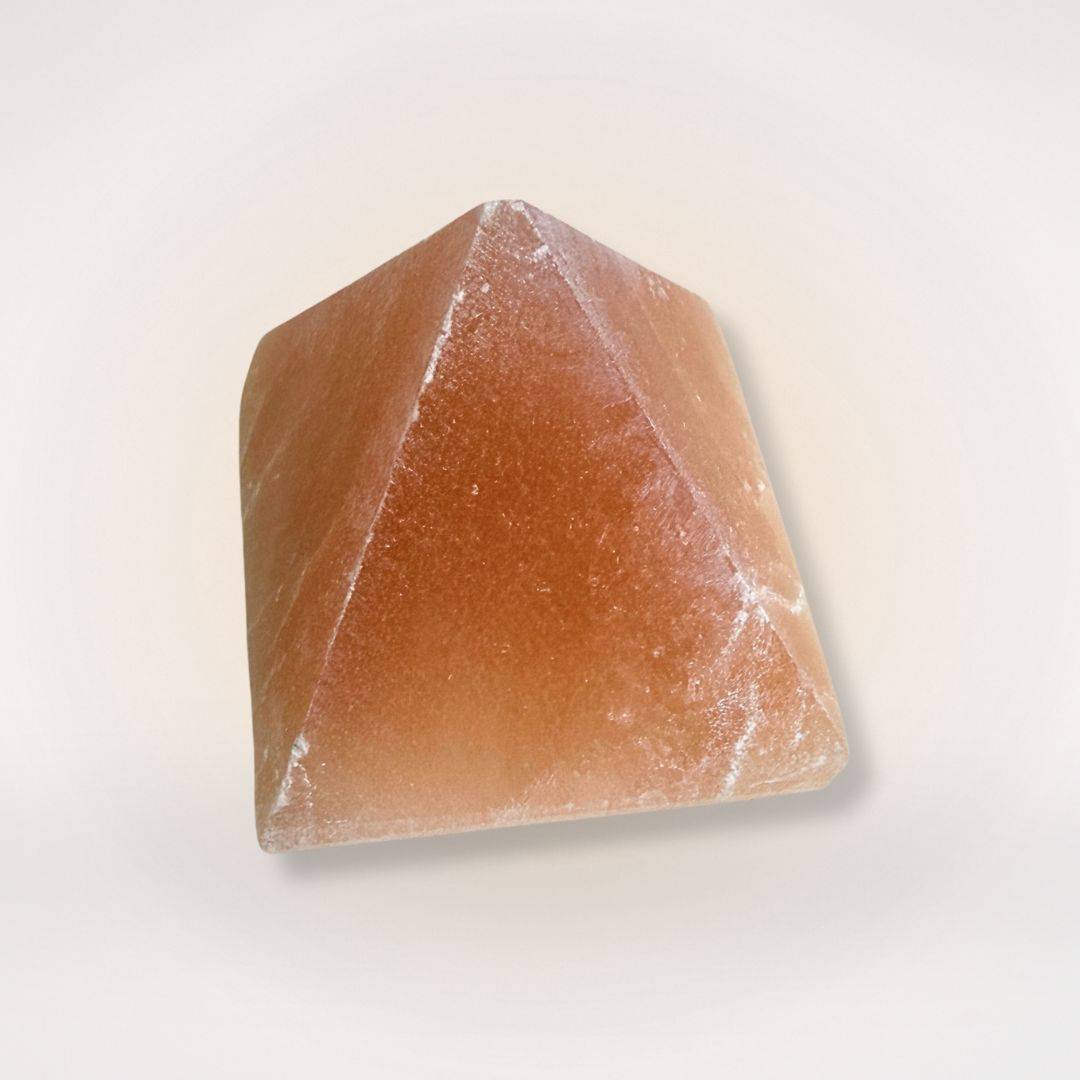 Orange Selenite Pyramid for clarity and balanced energy, ideal for home decor and meditation spaces. Smooth finish with natural crystal texture.