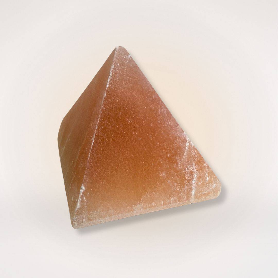 Polished Orange Selenite Pyramid showcasing its natural crystal structure, used for clarity and energy balancing in home decor.