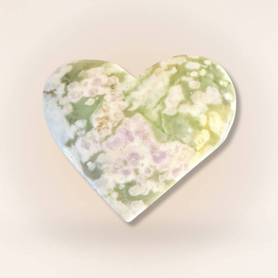 Peace Jade heart palm stone with vibrant green and lavender tones, crafted from serpentine and stichtite for soothing energy.
