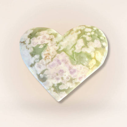 Peace Jade heart palm stone with vibrant green and lavender tones, crafted from serpentine and stichtite for soothing energy.