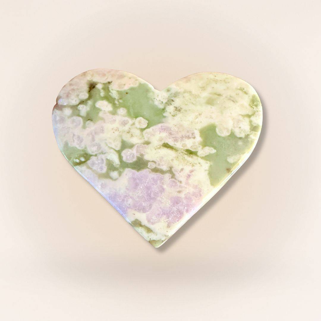 Lavender Serpentine and Stichtite Peace Jade palm stone in heart shape, promoting calm and emotional healing in collectible form.