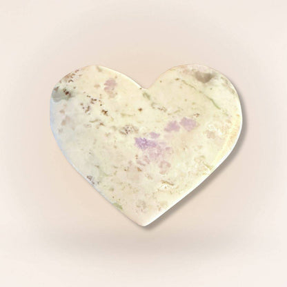 Light-toned Peace Jade heart palm stone with subtle lavender and green hues, made from serpentine and stichtite for inner peace.