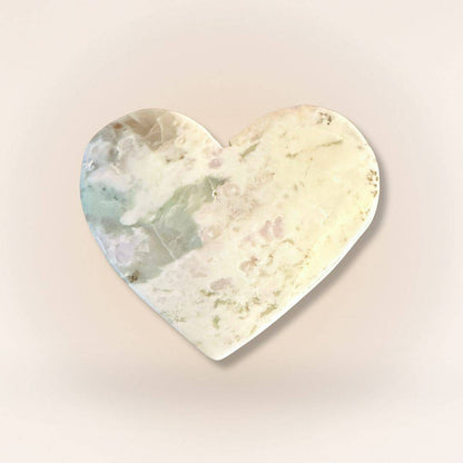 Creamy pastel Peace Jade heart palm stone with soft lavender and green swirls, carved from serpentine and stichtite for balance.