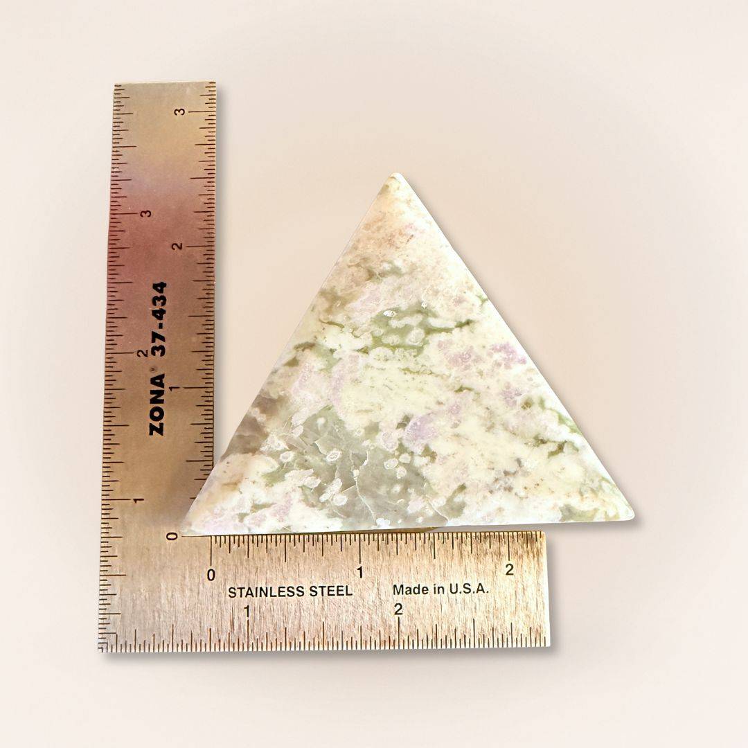 Triangle Peace Jade palm stone shown with ruler for size reference, featuring calming lavender and green serpentine and stichtite.