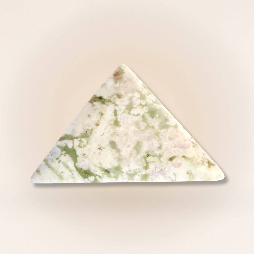 Peace Jade triangle palm stone with pastel green and lavender hues, carved from serpentine and stichtite for emotional balance.