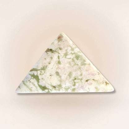 Peace Jade triangle palm stone with pastel green and lavender hues, carved from serpentine and stichtite for emotional balance.