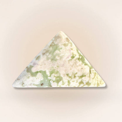 Triangle-shaped Peace Jade palm stone with soft green and lavender patterns, made from serpentine and stichtite for calm energy.
