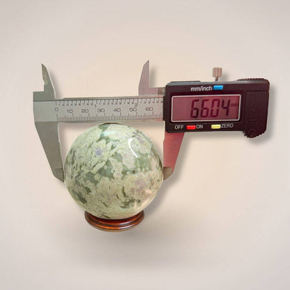 Peace Jade Sphere 66mm measured with digital caliper, confirming size for collectors seeking heart-centered crystal energy tools.