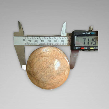 Flashy Peach Moonstone Sphere — Nurturing & Balancing measured at 71.19mm with digital caliper, showcasing size for gemstone collectors.