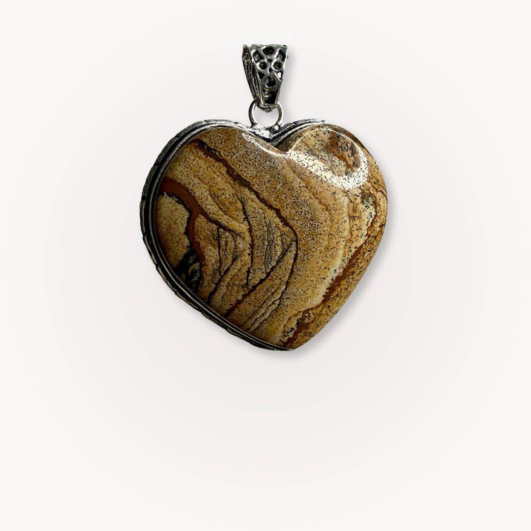 Close-up of Picture Jasper heart pendant from the Still Point Aligned Pairing, showcasing earthy tones and natural stone patterns in a silver setting.